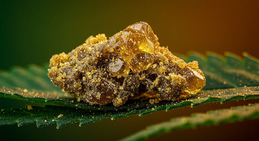 Macro shot of golden THCA hash crystals on raw cannabis leaves with a green and amber gradient background, symbolizing therapeutic purity.