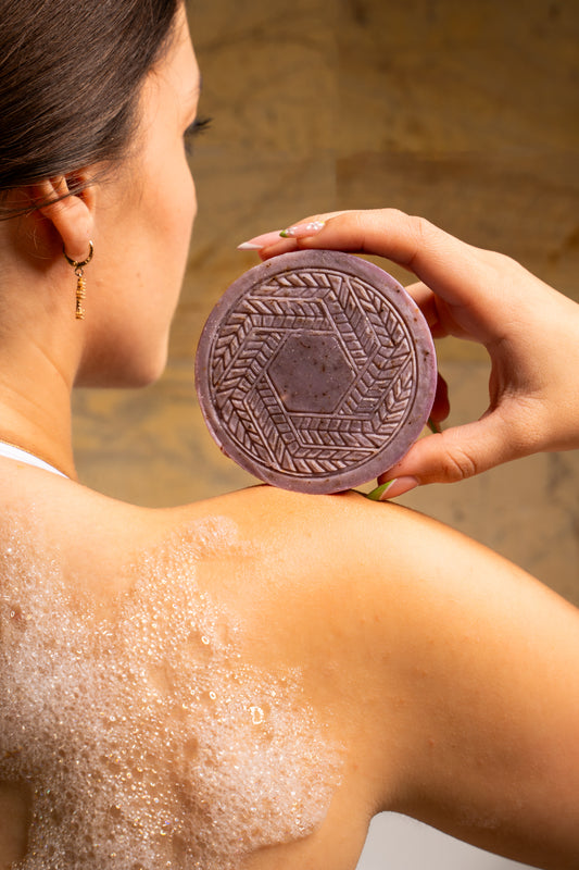 Organic CBD lavender soap bar placed next to fresh lavender sprigs, highlighting its soothing properties, floral fragrance, and skin-nourishing botanicals.