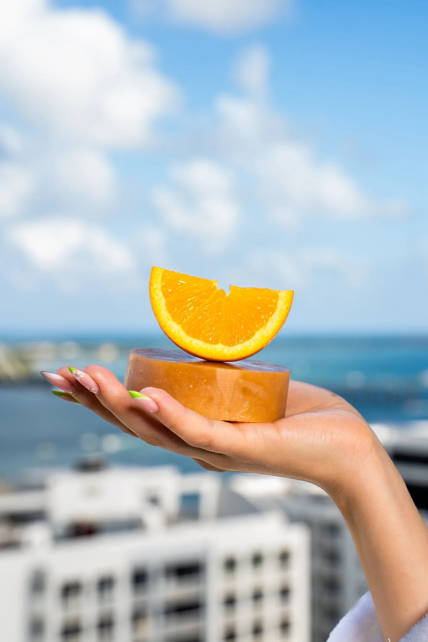 CBD-infused soap bar with a fresh orange placed on top, highlighting its citrus essential oils, nourishing botanicals, and refreshing scent | Hurcann