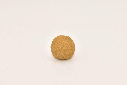 Close-up of a Hurcann THCa Hash Rock, showcasing a dense cannabis nug infused with high-THCa distillate and coated in a thick layer of kief for maximum potency and a smooth, flavorful smoke.