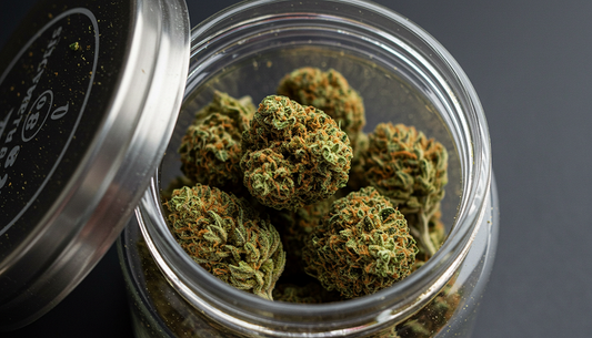 A close-up of Delta-8 Moon Rocks in a glass jar, highlighting their kief-covered texture and rich, golden-green hues.