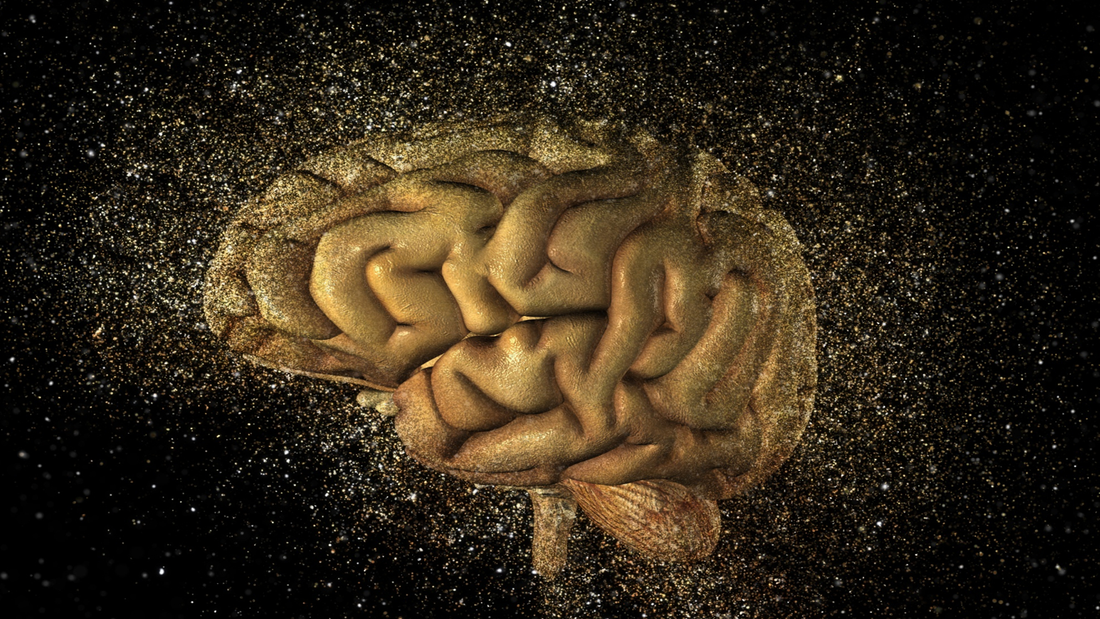 A human brain covered in shimmering gold dust, suspended against a dark cosmic background, symbolizing intelligence, creativity, and the power of thought