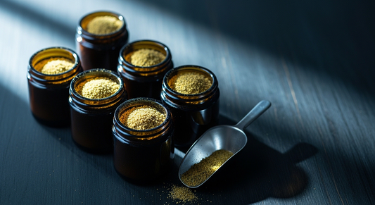 Amber glass jars filled with golden kief on wooden table showing proper cannabis concentrate storage setup