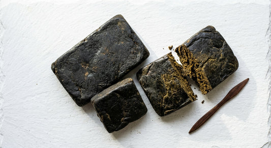 egyptian hash dark slabs flat lay showing near-black resin concentrate texture 2026