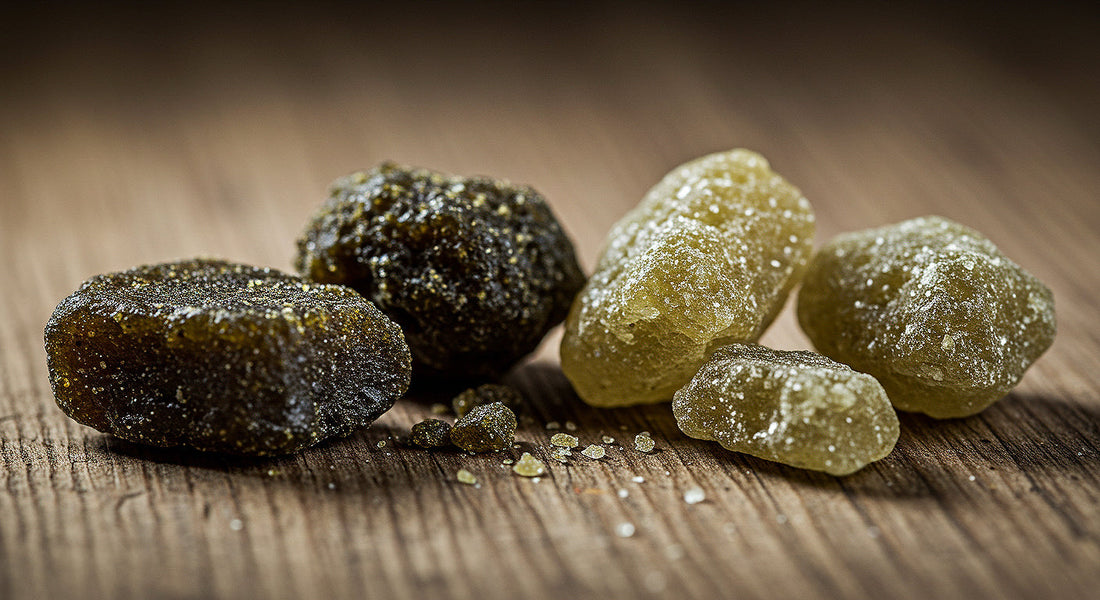 A detailed shot of hash rocks and moon rocks placed on a rustic wooden table, emphasizing their unique textures, colors, and the differences between these cannabis concentrates.