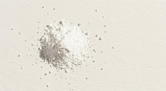 THCA powder for sale fine white hemp isolate crystals on white surface Hurcann