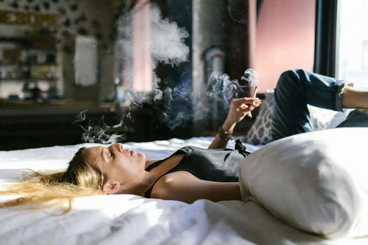 woman smoking thca hemp flower on her bed | Hurcann