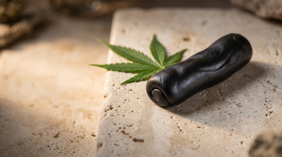 Pliable black hash with a hemp leaf on stone