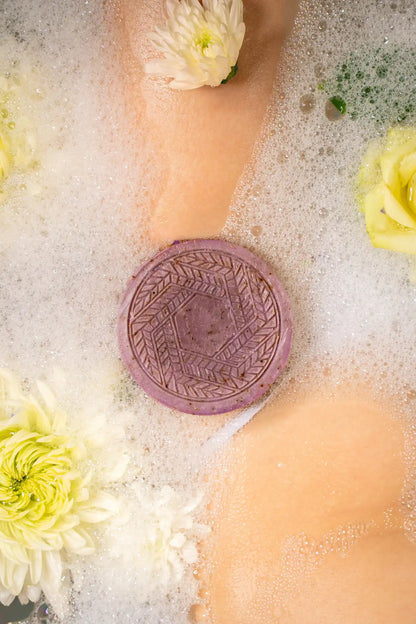 Relaxing lavender CBD soap bar resting on a wooden soap dish in a spa-like bathroom, promoting stress relief, hydration, and a luxurious skincare experience | Hurcann