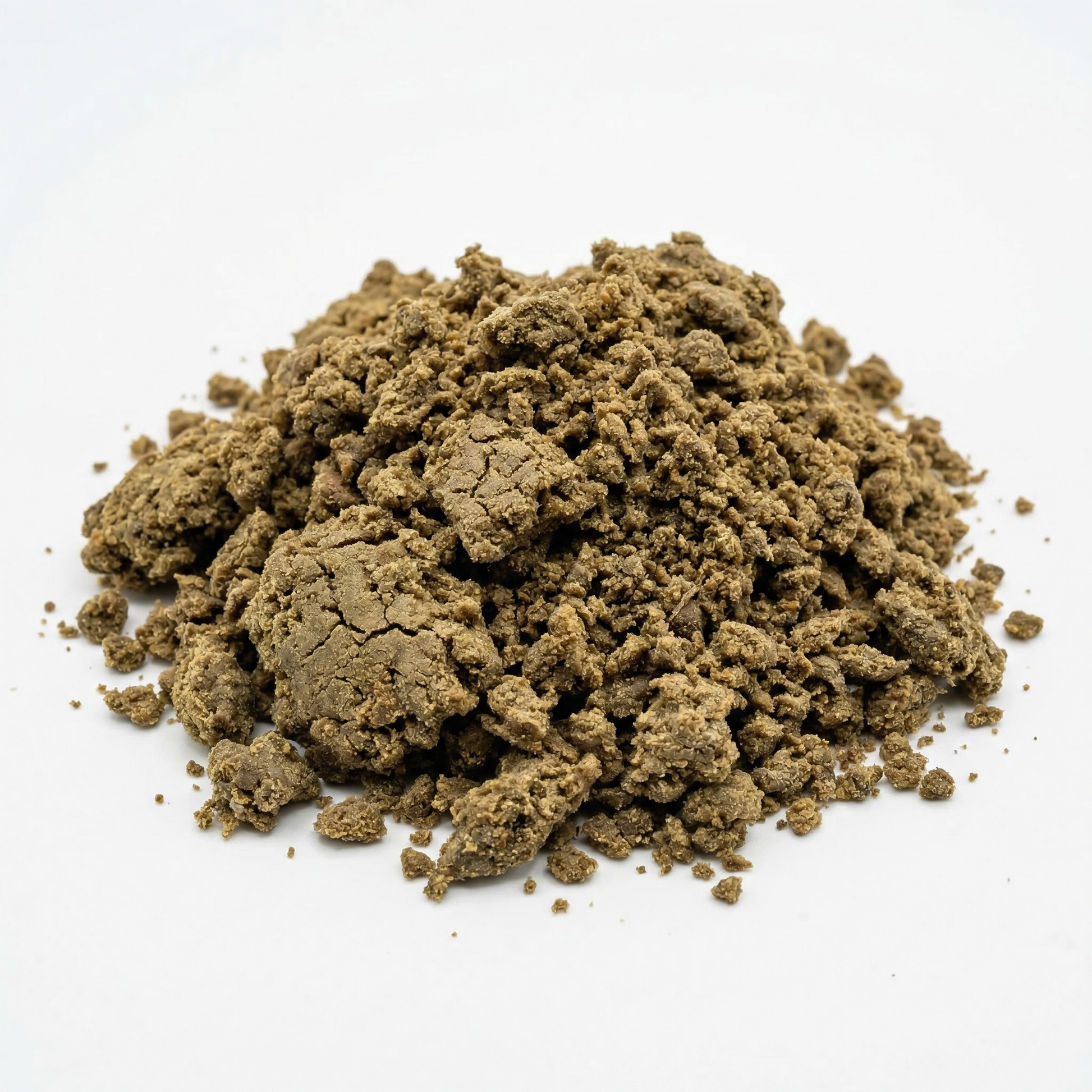 Large loose mound of crumbled CBD bubble hash on a white background, warm olive-brown granular texture with varied chunk sizes scattered around the base
