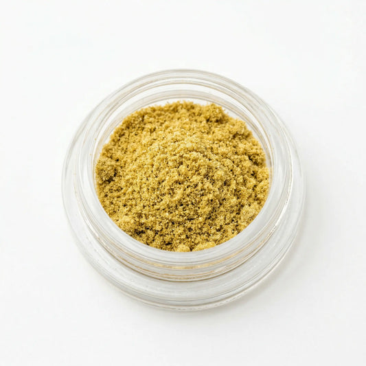 CBD kief in an open glass jar on white background — golden hemp-derived dry-sift CBD kief powder | Hurcann