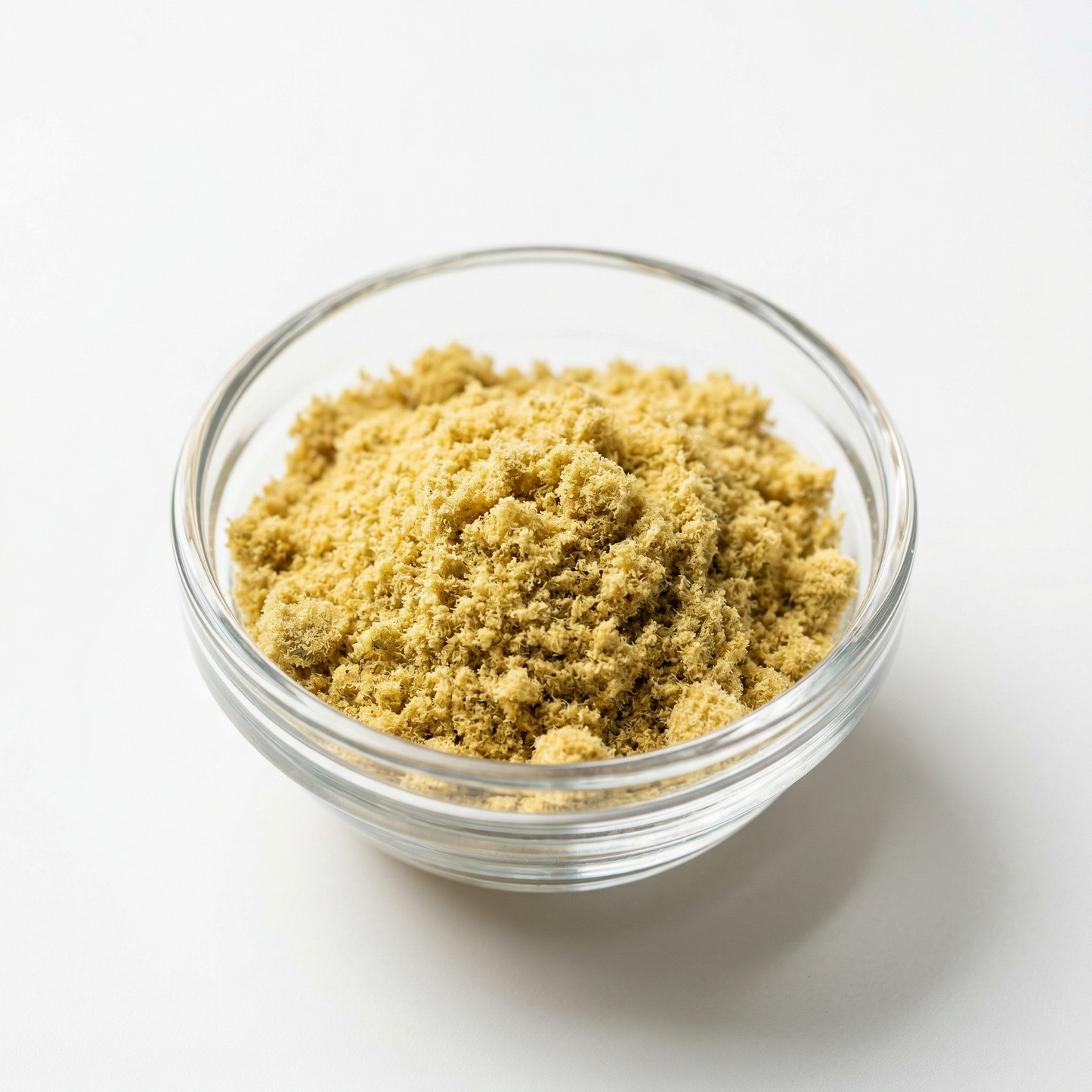 CBG kief powder in a glass bowl on white background — fine white hemp kief from CBG-dominant hemp flower