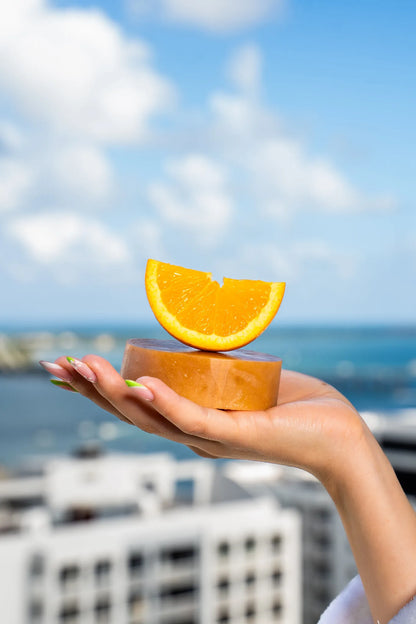 CBD-infused soap bar with a fresh orange placed on top, highlighting its citrus essential oils, nourishing botanicals, and refreshing scent | Hurcann