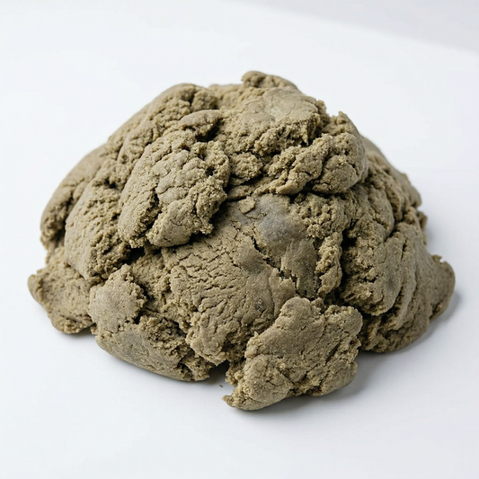Large mound of loose THCA bubble hash on a white background, showing a rough textured surface with olive-brown and taupe tones