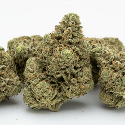 Windu buds display a mix of bright green and orange hues with crystal-clear trichomes