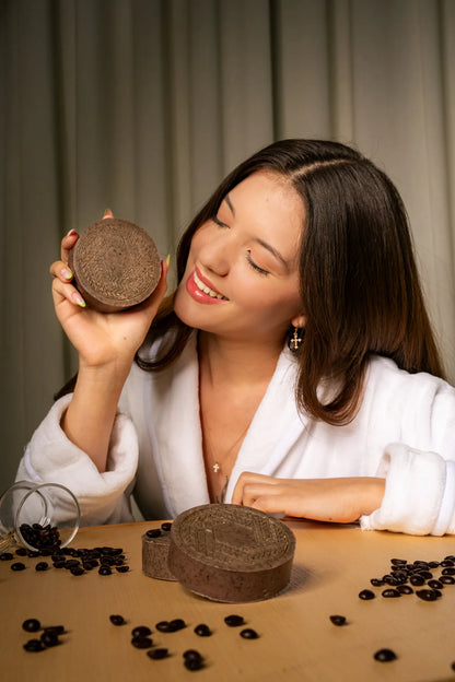 Young woman posing with a CBD soap bar infused with coffee, highlighting its antioxidant-rich formula for glowing, rejuvenated skin | Hurcann