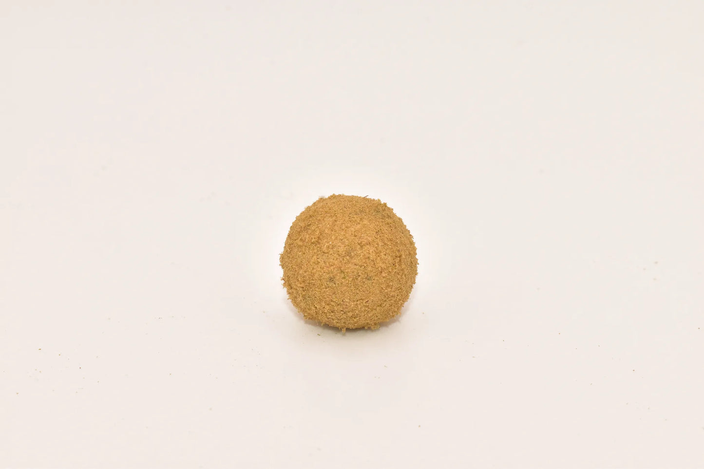 Close-up of a Hurcann THCa Hash Rock, showcasing a dense cannabis nug infused with high-THCa distillate and coated in a thick layer of kief for maximum potency and a smooth, flavorful smoke.