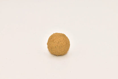 Close-up of a Hurcann THCa Hash Rock, showcasing a dense cannabis nug infused with high-THCa distillate and coated in a thick layer of kief for maximum potency and a smooth, flavorful smoke.