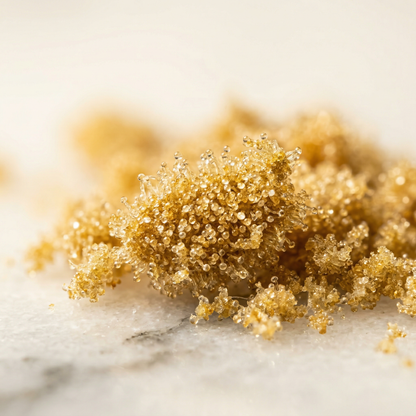 Extreme macro close-up of THCA kief trichomes — golden crystalline hemp trichome heads and stalks