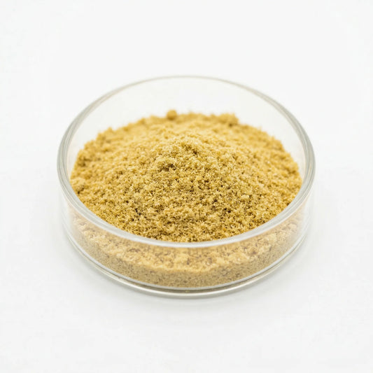 THCA kief powder in a glass dish on white background — golden hemp-derived dry-sift trichomes