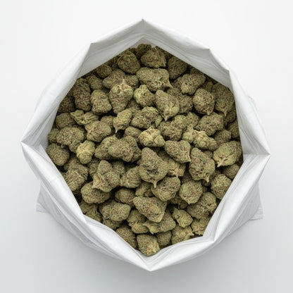 Cream Cake features dense, frosty buds with shades of light green and lavender beneath a thick layer of sparkling trichomes