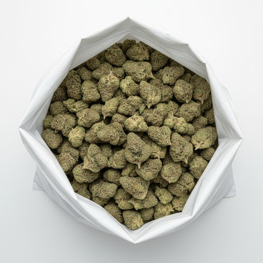 Cream Cake features dense, frosty buds with shades of light green and lavender beneath a thick layer of sparkling trichomes